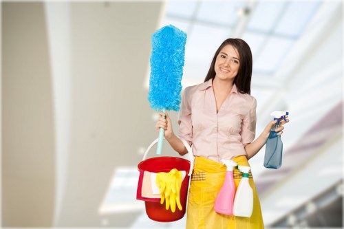 Staff member using protective gloves and safe cleaning practices during carpet cleaning
