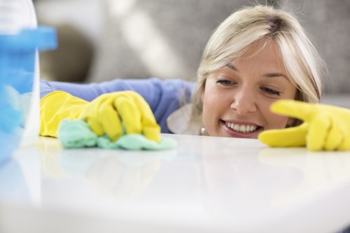 Professional cleaner preparing a rental flat for guests in SW18